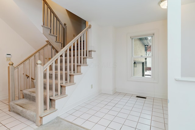 staircase with tile patterned flooring