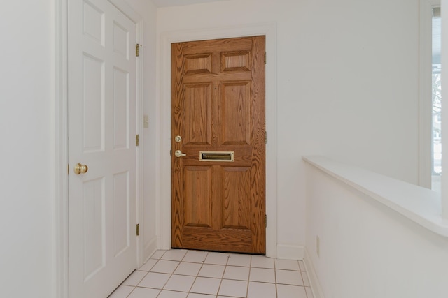 doorway featuring light tile patterned flooring