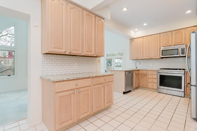 kitchen with backsplash, light brown cabinets, stainless steel appliances, light tile patterned floors, and light stone counters