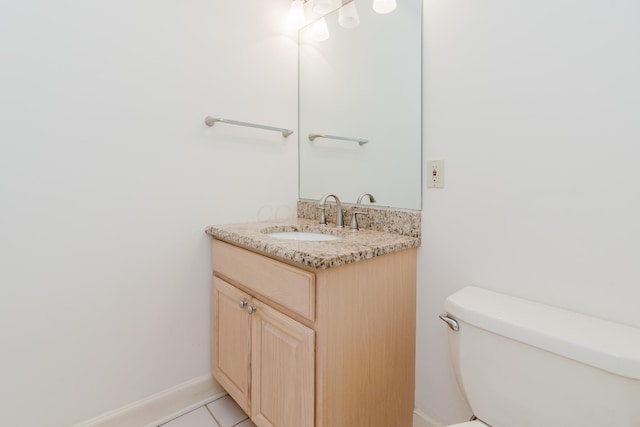 bathroom with toilet, tile patterned flooring, and vanity