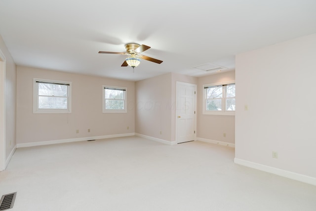 unfurnished room featuring ceiling fan, light carpet, and a healthy amount of sunlight