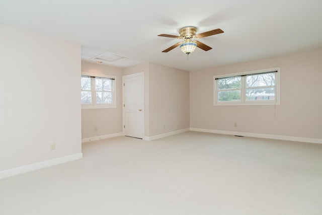 carpeted spare room with ceiling fan