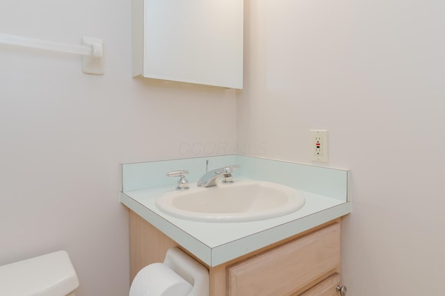 bathroom with toilet and vanity