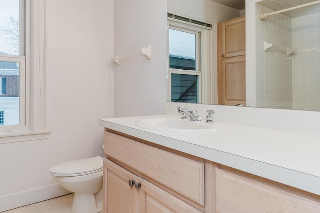 bathroom with tile patterned floors, toilet, vanity, and a tile shower