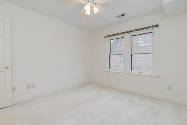 empty room featuring light carpet and ceiling fan