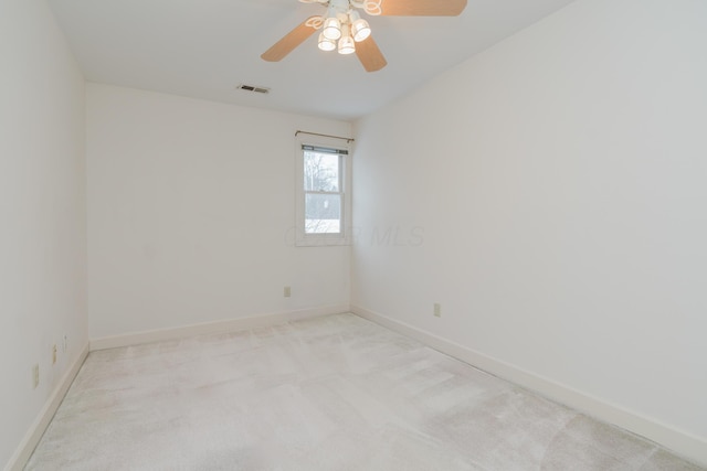 unfurnished room with ceiling fan and light colored carpet