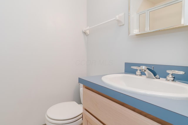 bathroom with toilet and vanity