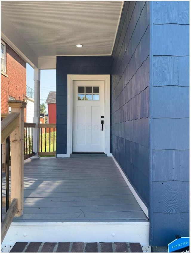 view of exterior entry featuring a porch