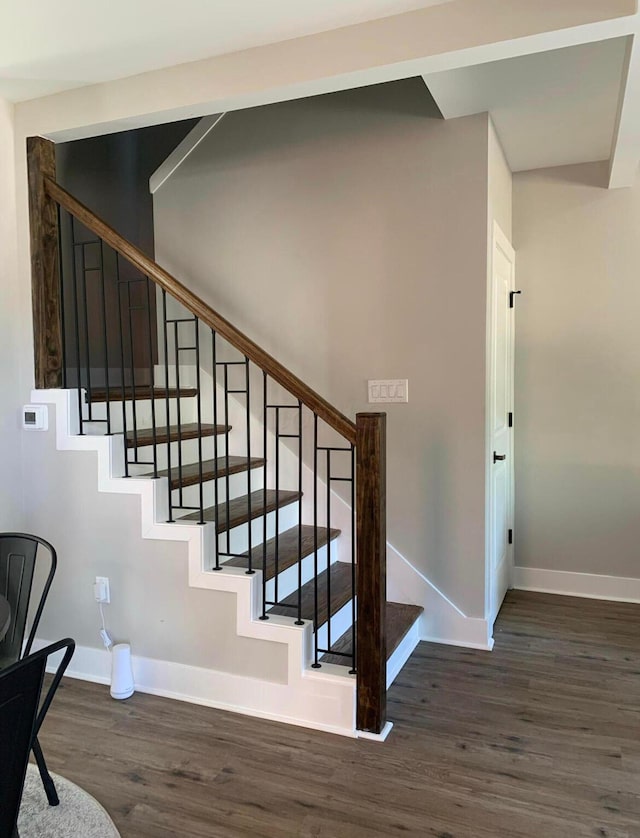 stairway featuring hardwood / wood-style flooring