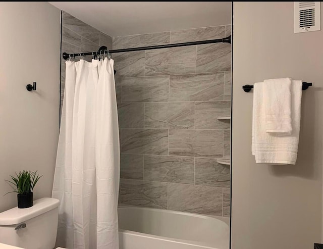 bathroom with toilet and shower / tub combo