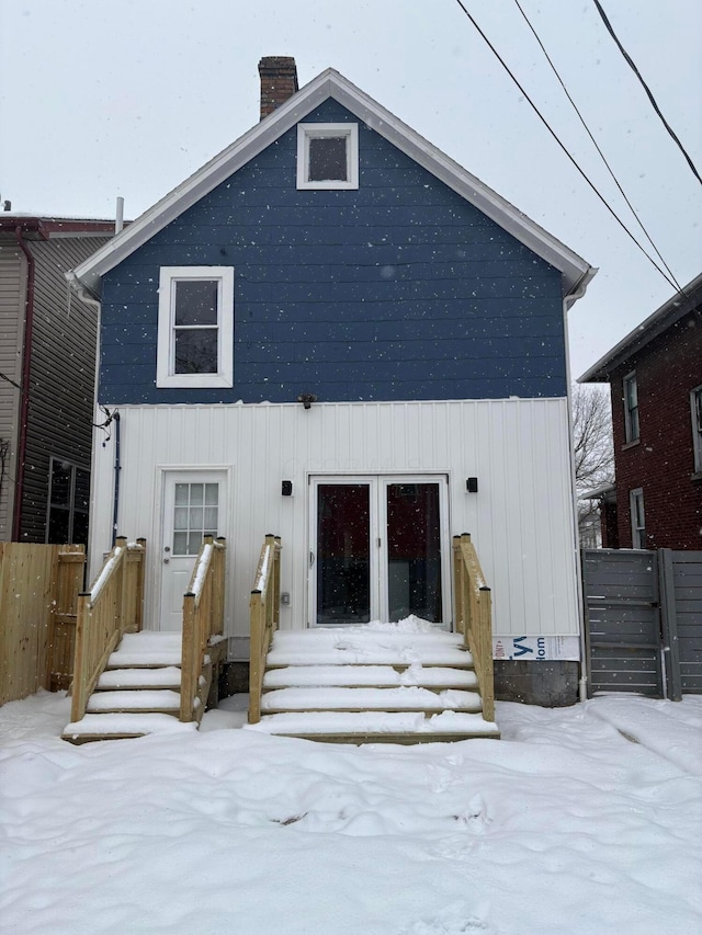 view of snow covered rear of property