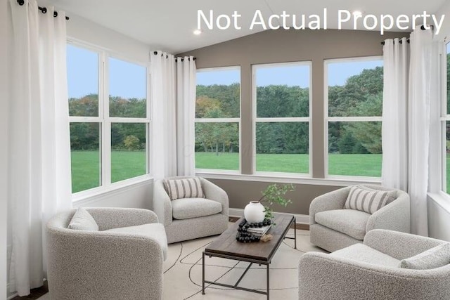 sunroom / solarium featuring vaulted ceiling