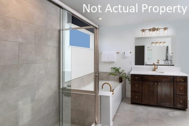 bathroom with plus walk in shower, tile patterned floors, and vanity