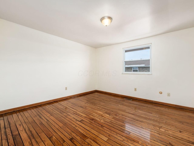 unfurnished room with hardwood / wood-style floors