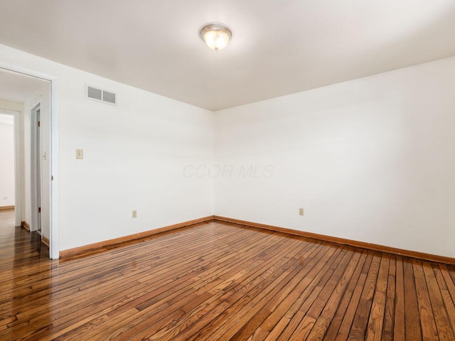 spare room with dark hardwood / wood-style flooring