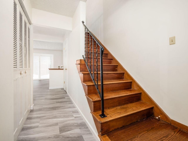 stairs with hardwood / wood-style floors