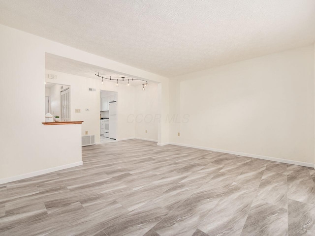 unfurnished living room with a textured ceiling