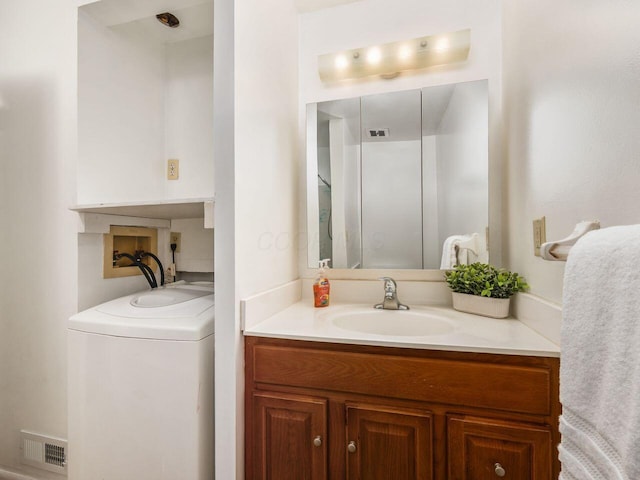 bathroom featuring washer / clothes dryer and vanity