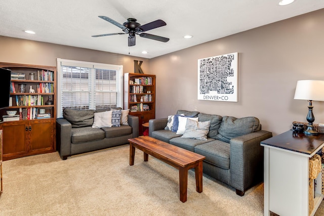 living room with light colored carpet and ceiling fan