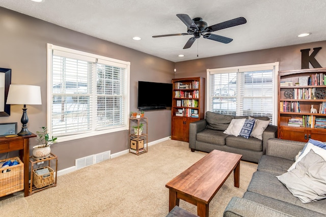 living room with ceiling fan and light carpet