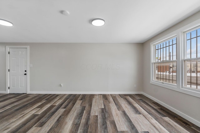 spare room with dark hardwood / wood-style flooring