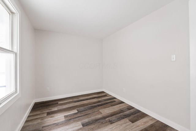 spare room with dark wood-type flooring