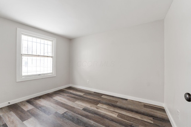 unfurnished room featuring dark hardwood / wood-style floors