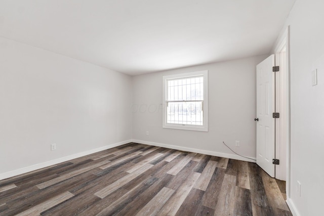 spare room with dark hardwood / wood-style flooring