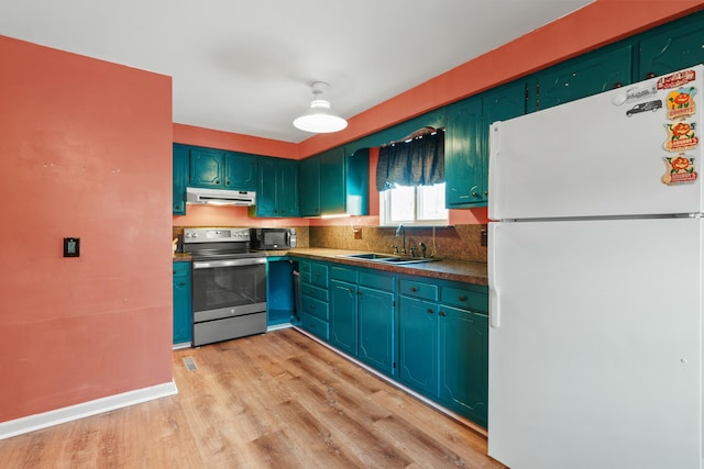 kitchen with white refrigerator, sink, stainless steel range with electric cooktop, light wood-type flooring, and tasteful backsplash