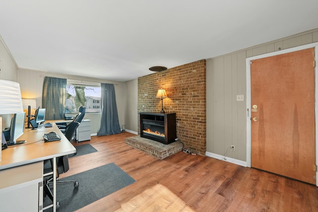 home office with a fireplace and hardwood / wood-style flooring