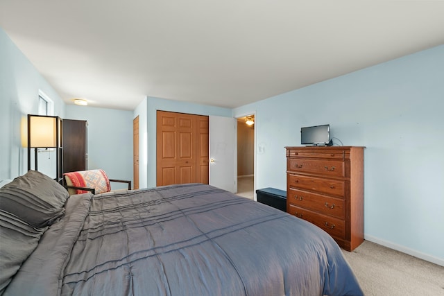 bedroom with light colored carpet and a closet