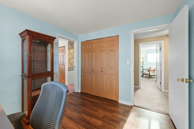 home office with dark hardwood / wood-style flooring