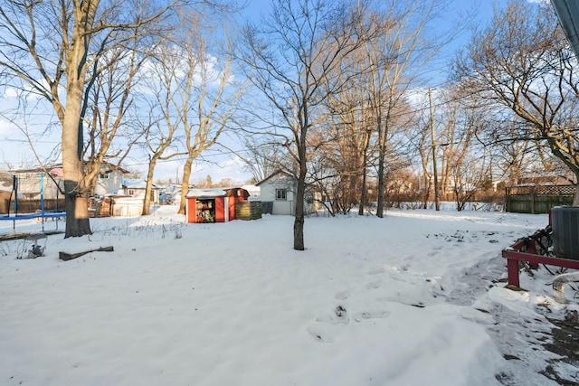 snowy yard with a trampoline