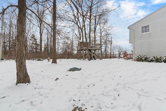 snowy yard featuring a deck