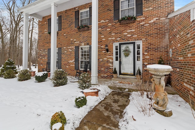 view of snow covered property entrance