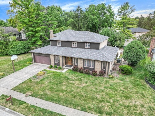 view of front of house with a garage and a front yard