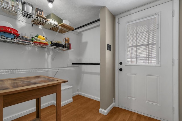 interior space with wood-type flooring and a textured ceiling