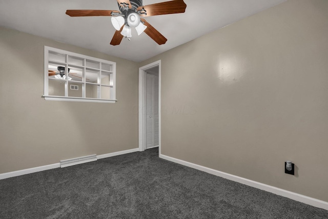 unfurnished room featuring dark carpet and ceiling fan