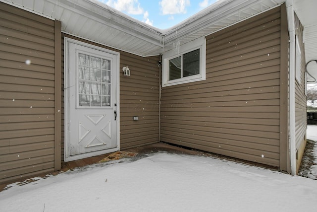 view of snow covered property entrance