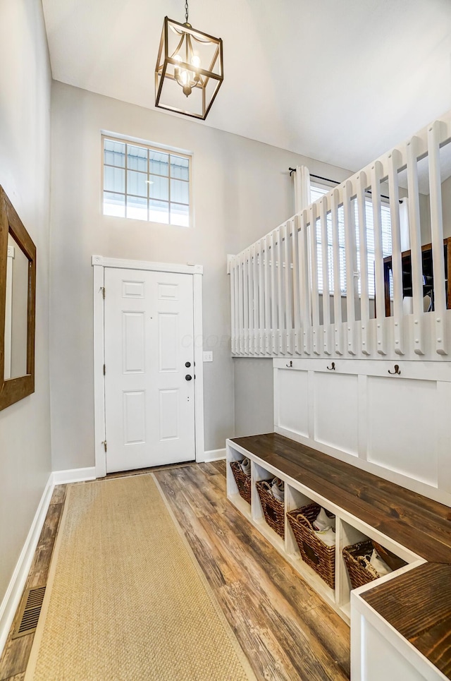 foyer entrance featuring a chandelier and wood-type flooring