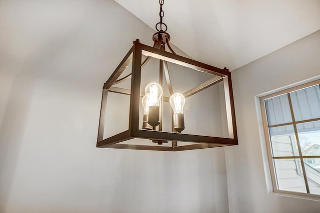 interior details featuring an inviting chandelier