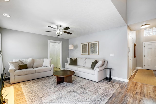 living room featuring ceiling fan and wood-type flooring