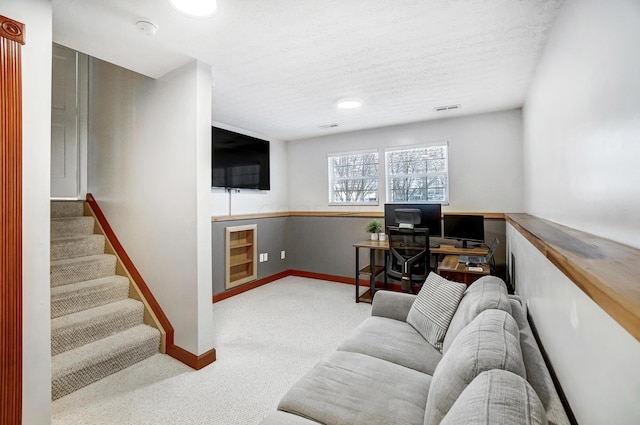 living room with a textured ceiling and light carpet