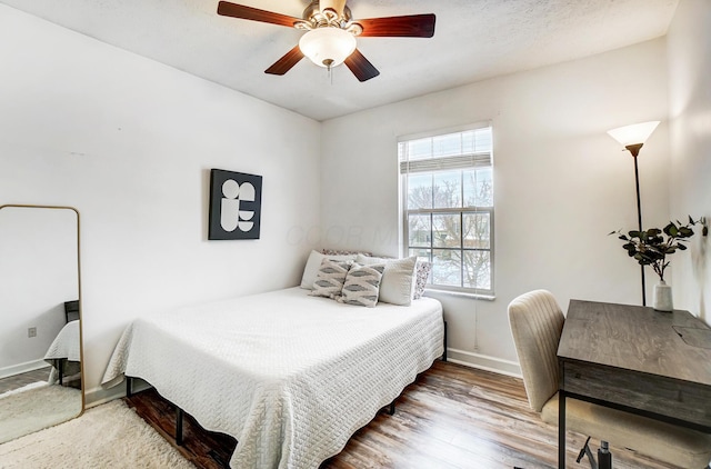 bedroom featuring ceiling fan and hardwood / wood-style floors