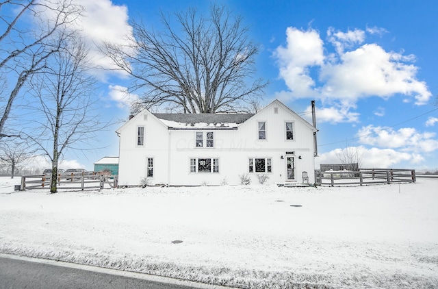 view of snow covered rear of property