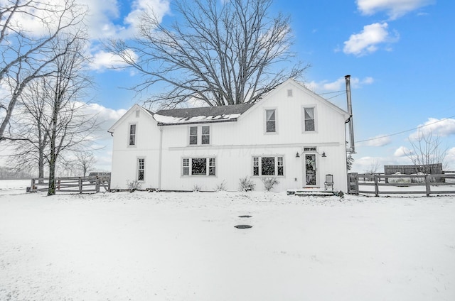 view of snow covered rear of property