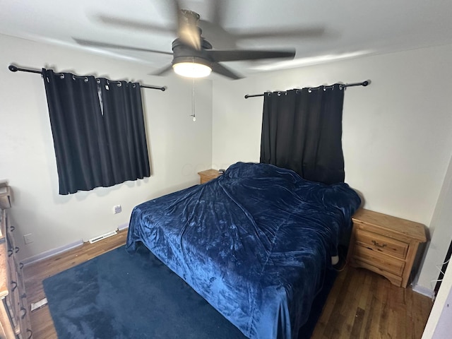 bedroom with ceiling fan and dark wood-type flooring