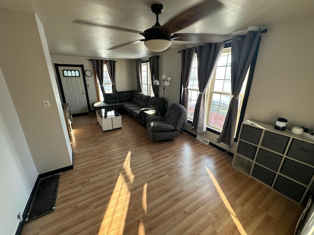 living room with ceiling fan and hardwood / wood-style floors