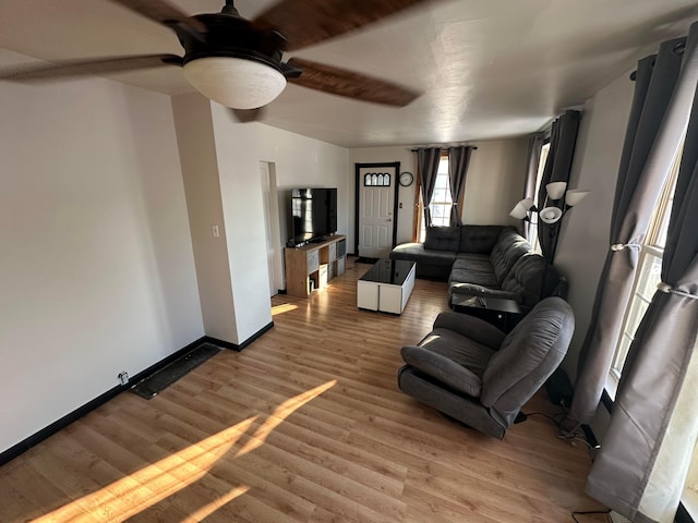 living room with ceiling fan and wood-type flooring