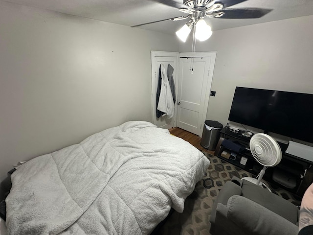 bedroom with ceiling fan, a closet, and dark hardwood / wood-style floors